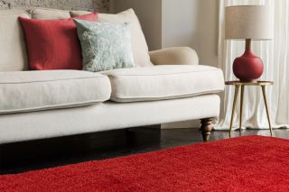 cream sofa with red rug